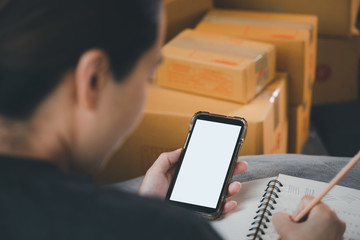 Online Selling or Online Shopping concept.Asian woman works at home by selling online and he is currently accepting and taking orders.business of seller merchant online ecommerce.