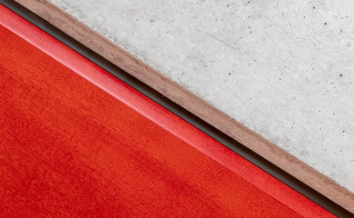 red lacquered wood and raw cement surface close up background