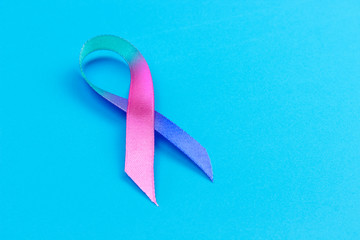 ribbon symbolizing World Thyroid Day on a blue background, copy spaсe