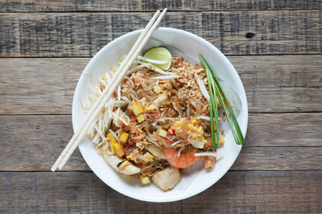 Fried noodle Thai style with prawns Thailand call Pad Thai, Stir-fried noodle Thai style on the wood table.