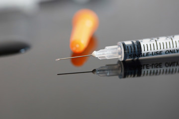 Closeup macro hypodermic syringe
and drop water vaccine for anti Covid corona virus, Hope to...