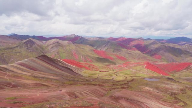 Panning of beautiful rocky mountains against cloudy sky, idyllic shot of landscape - Rainbow Mountain, Peru
