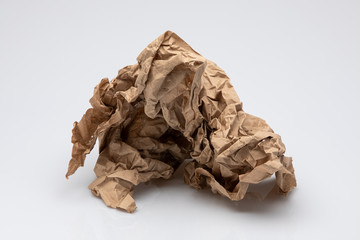 Crumpled brown paper isolated in front of white background