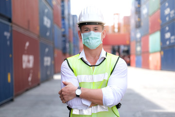 American engineers workers wear a safety vest and mask to prevent coronavirus. Standing arms...