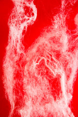 Abstract halloween background. Spider web on a red background. Copy space.