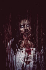 Portrait of asian woman make up ghost face with blood,Horror scene,Scary background,Halloween...