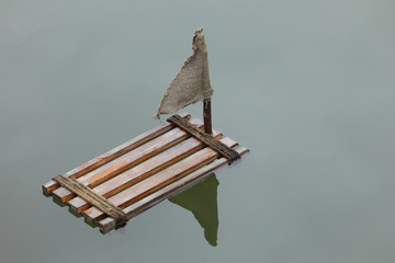 old wooden raft floating on the water