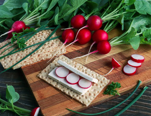 diet sandwich made from fresh radish, soft cheese and bread rolls on a wooden background. concept of healthy eating, losing weight and healthy foods