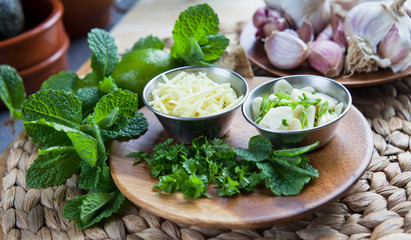 Sliced garlic and ginger with healthy herbs -  coriander, mint and lime -  healthy diet ingredients with Asian inspiration.