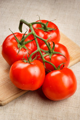 Juicy red tomatoes on a cutting board