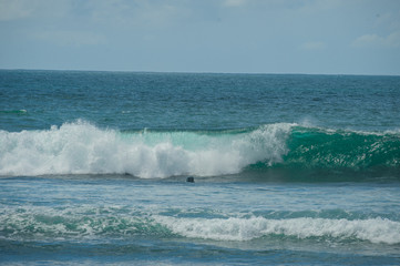 Ocean waves on a sandy beach. Tropical background.