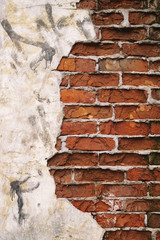 background texture of old red brick house wall with gray cement. Close up. Copy space