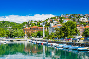 Fototapeta na wymiar Croatia, city of Rijeka, skyline view from Delta and Rjecina river over the boats in front, colorful old buildings, monuments and Trsat on the hill in background