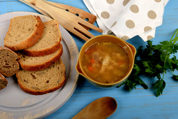 tasty tripe soup in a small bowl next to dry bread