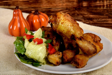fried chicken legs and green salad with sunflower seeds