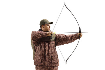 Man hunter in a camuflage uniform aiming with a bow and arrow