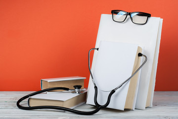 Medical prescription blank paper form for patients record with doctor's stethoscope books,...