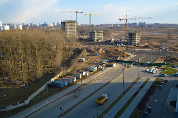 Top view of a large construction site with cranes and buildings houses concrete monolithic frame panel multi-storey skyscrapers of the big city of the metropolis
