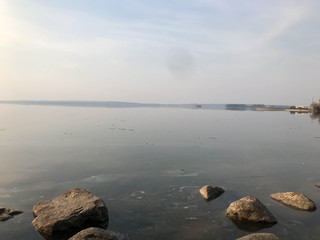 Large round beautiful natural stones cobblestones in water, sea, lake, river. Background, texture