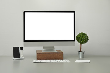 Modern workplace with computer and charging devices. Interior design