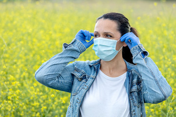 Brunette woman with a mask in the countryside