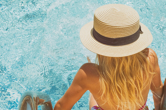 Pretty little girl in swimming pool, summer vacations.