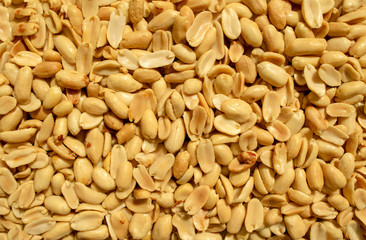 Background made of peeled peanuts. Healthy snack and food. Salted and spicy peanuts backdrop. Top view