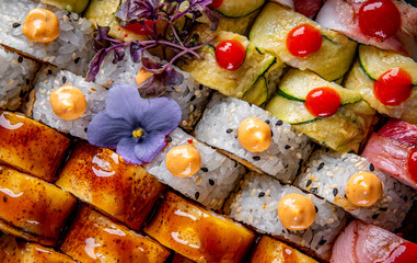 set of sushi roll with salmon, avocado, cream cheese, cucumber, rice, caviar, eel, tuna in plate