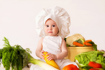 Healthy nutrition Happy little girl in an apron and hat prepares a vegetable salad. Cook