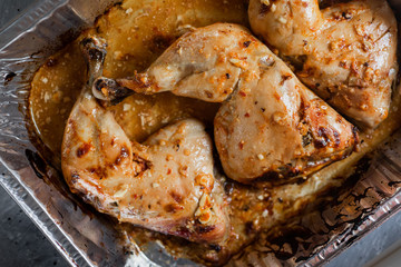 Close up of roasted chicken in foil cooked at home
