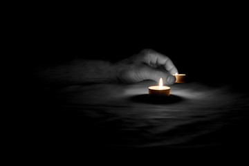 A candle is lit in memory of the victims.