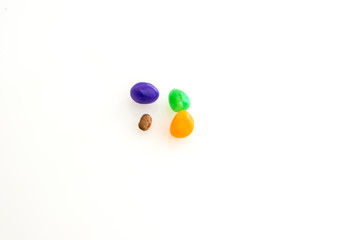 Larger jelly beans gang up on a smaller, different bean. 