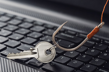 phishing  personal data , key and hook on computer keyboard.