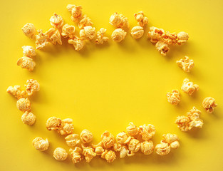 Frame of Caramel Popcorn on Yellow background 