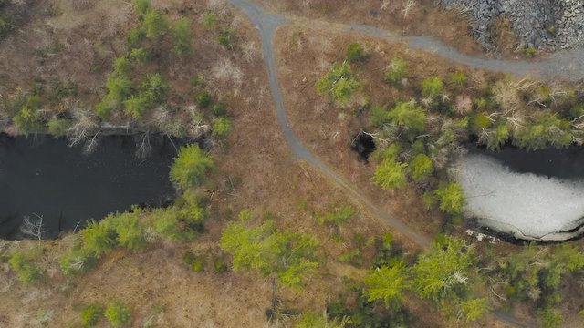 Road into old abandoned slate mine in Monson Maine ascending aerial 