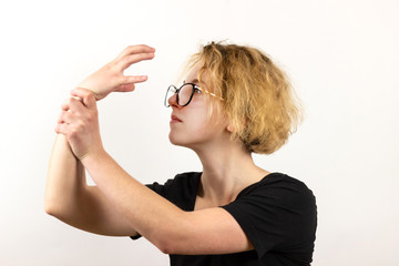 The concept of complexity of choice. The girl looks at her hands, holds one of her hands with the...
