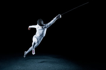 The fencer moves forward with a sword in his hand. Sport concept. - obrazy, fototapety, plakaty