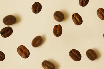 Coffee beans levitate against a bright background soft focus  