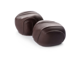 Delicious dark chocolate candies isolated on white