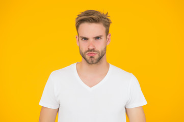 Obraz premium handsome guy with light unshaven. sexy man on yellow background. male beauty style. charismatic fashion model. casual summer outfit. young serious student. barbershop concept