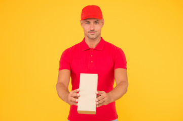 Service plus quality. Serious guy hold parcel yellow background. Man delivery service. Express courier service. Shipping and delivery service. Sending by parcel post. Worth relying on us, copy space