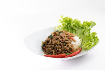 Thai food, Stir-fried hot and spicy pork with holy basil, served with white rice on white background.