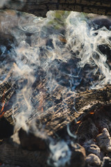 Puffs of smoke from the bonfire the light vertical