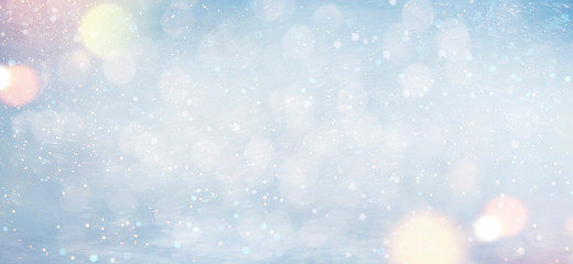 Christmas and New Year background with snow and light bokeh