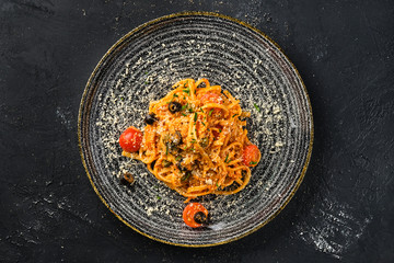 Ovrthead view of pasta with tomato and olives