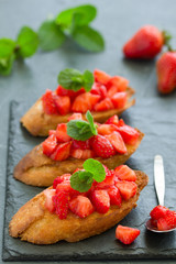 Bruschetta with strawberries and basil. Selective focus