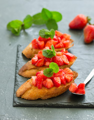 Bruschetta with strawberries and basil. Selective focus
