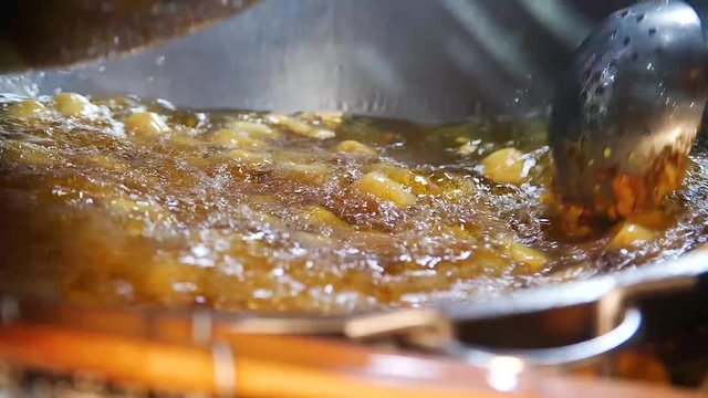 Cheese Sweet potato ball cooked in oil at Shilin Night Market, Taipei, Taiwan. Taiwanese street food.
Low angle, parallax movement, slow motion, HD.