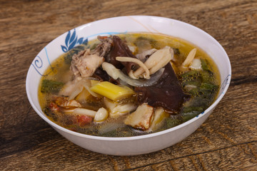 Thai style soup with meat and mushrooms