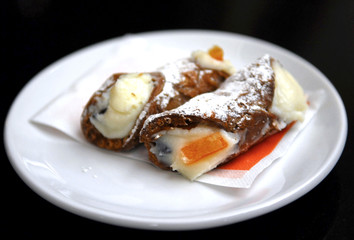 Fresh italian cannoli on the table in sicilian cafe. Delicious desert. Sweet lifestyle.